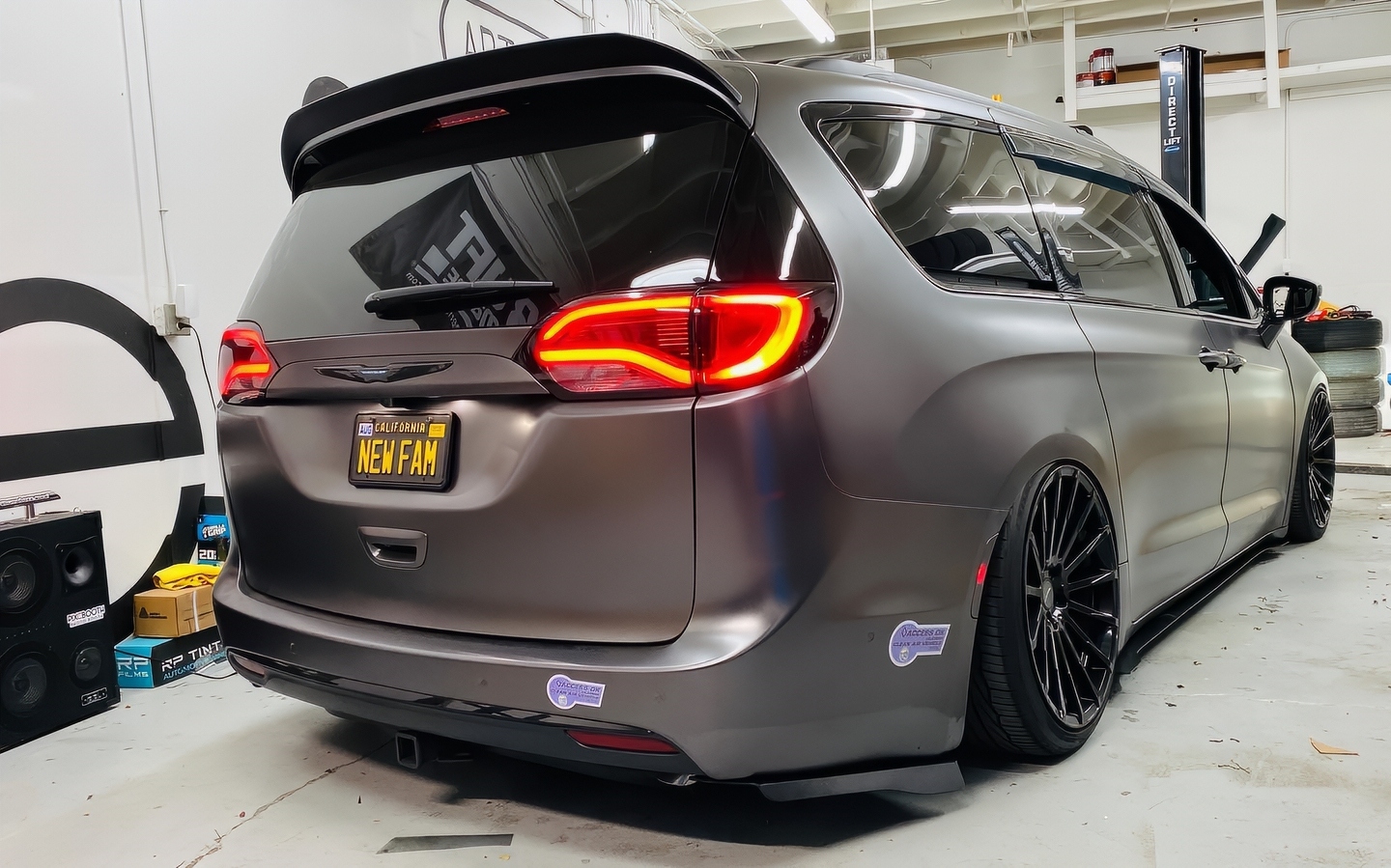 Slammed Chrysler Pacifica minivan with tinted windows outside VK Garage
